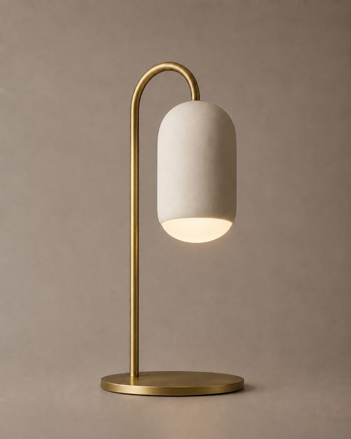 Ova Mensa table lamp with a brass arched stem