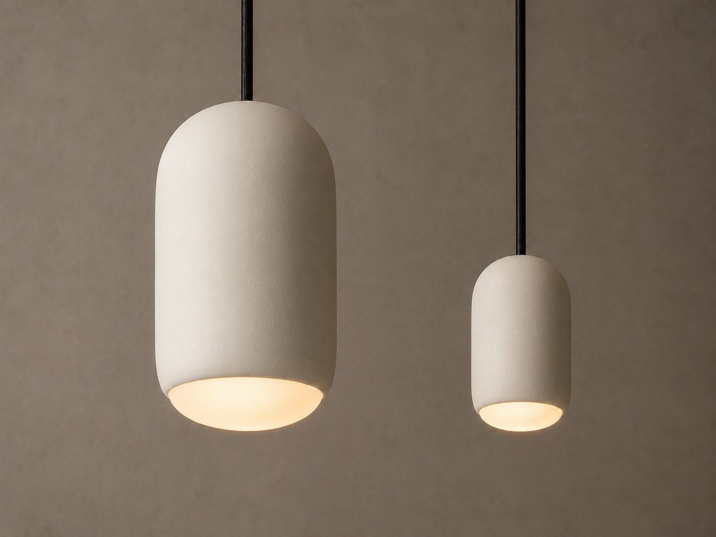 Ova Piccola: a large and a small capsule pendant hung as a pair