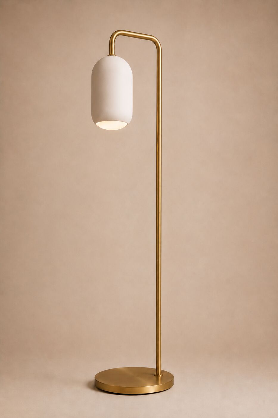 The Ova floor lamp: a plaster capsule on a tall brass stem