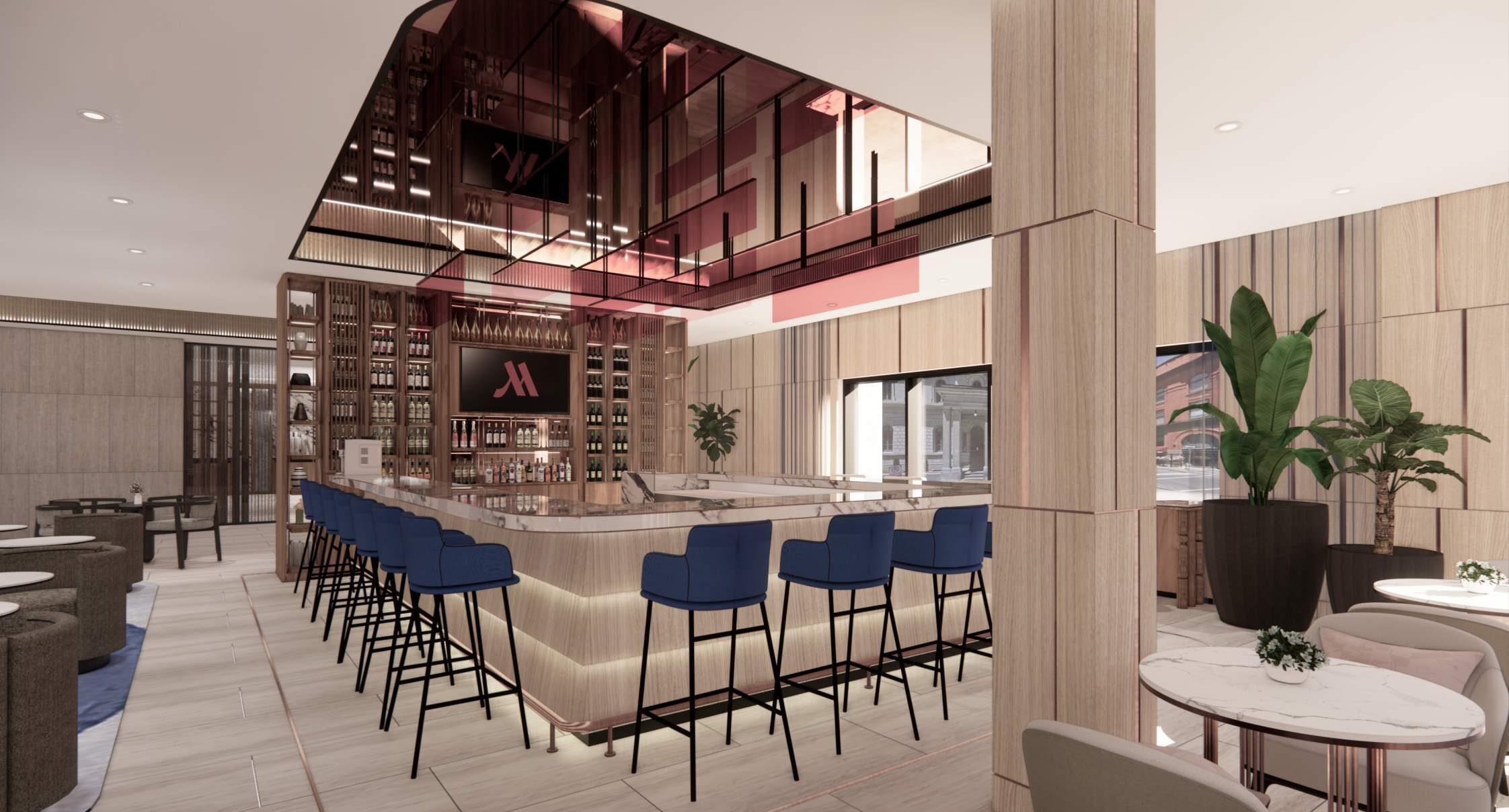 The great-room bar with blue stools and a lit back bar