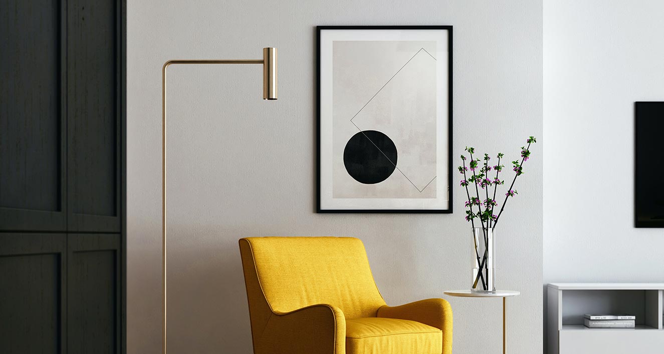 A yellow chair and a black framed picture