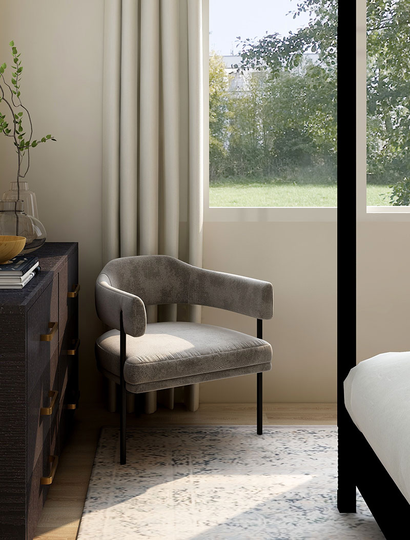 A chair in front of a window with a view of the grass.